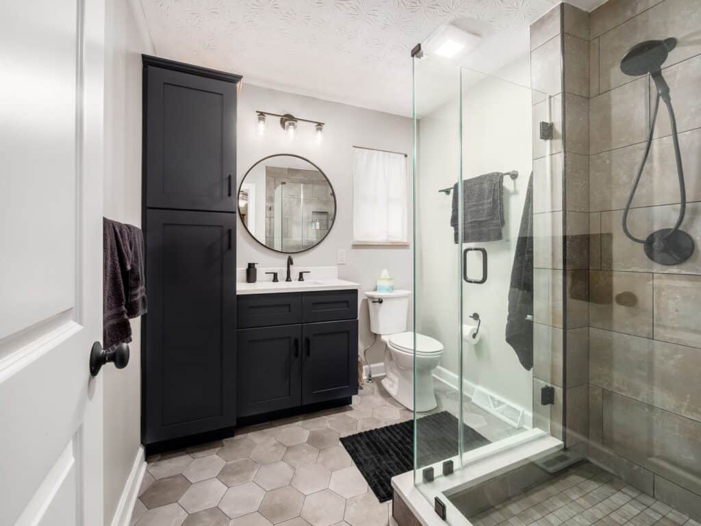 bathroom remodeling with masculine dark tones and upgraded shower